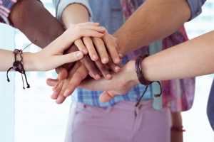 Group of executives forming handstack